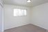Carpeted bedroom with a single window at Fairbrook in Salt Lake City, UT