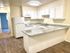 Updated kitchen with white cabinets and gray counters at Fairbrook in Salt Lake City, UT
