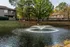 Pond with fountain beside apartment buildings at Hickory Forest in Memphis, TN