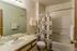Model bathroom with tub and floral curtain at Hickory Forest in Memphis, TN