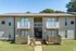 Two-story building with balconies and fenced patios at Hunter Oaks Apartments in Memphis, TN