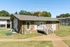 Stone clubhouse with a ramp and front porch at Hunter Oaks Apartments in Memphis, TN