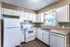 Kitchen with white cabinets and white appliances at Hunter Oaks Apartments in Memphis, TN