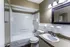 Bathroom with a tub-shower and dark-framed mirror at Hunter Oaks Apartments in Memphis, TN