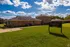 Brick homes and sign on a sunny green lawn at Jackson Heights Residential in West Memphis, AR