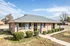 Single-story brick ranch home with shrubs at Jackson Heights Residential in West Memphis, AR