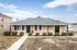 Ranch home with a hip roof and front lawn at Jackson Heights Residential in West Memphis, AR