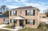 Two-story brick townhouse with black shutters at Jackson Heights Residential in West Memphis, AR