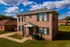 Two-story brick home on a green lawn at Jackson Heights Residential in West Memphis, AR