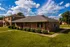 Row of brick ranch homes under blue sky at Jackson Heights Residential in West Memphis, AR
