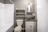 Bathroom with a wall shelf and gray vanity at Jackson Heights Residential in West Memphis, AR