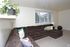 Cozy living room with sectional sofa and a bright window at Linden Colonial in Holladay, UT