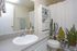 Bathroom with white vanity and potted plants at Linden Colonial in Holladay, UT
