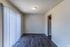Living room with sliding door and vertical blinds at Shadowbrook Townhomes in Memphis, TN