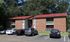 Red-roof brick apartment building with resident parking at Meadow Creek Apartments in Jackson, MS