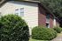 Landscaped shrubs along apartment building exterior at Meadow Creek Apartments in Jackson, MS