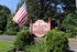 Sykes Park Manor entrance sign and American flag at Meadow Creek Apartments in Jackson, MS