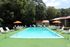 Outdoor swimming pool with lounge chairs at Meadow Creek Apartments in Jackson, MS