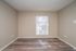 Townhome living room with wood-style flooring at Meadow Creek Apartments in Jackson, MS