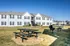 Picnic tables and grills on the lawn at Meadows West Memphis Apartments in West Memphis, AR