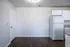 Living area with wood-style floors and kitchen view at Meadows West Memphis Apartments in West Memphis, AR