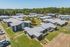 Low aerial view of townhome buildings and parking at Pines Apartments in Jackson, MS