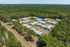 Aerial view of the community surrounded by pine forest at Pines Apartments in Jackson, MS