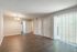 1 bedroom living room with wood-style floors and vertical blinds at Pines Apartments in Jackson, MS
