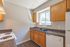 1 bedroom kitchen with oak cabinets and window over the sink at Pines Apartments in Jackson, MS