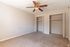 Carpeted bedroom with ceiling fan and double closets in 1 bedroom apartment at Pines Apartments in Jackson, MS