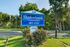 Blue Shadowbrook sign with landscaped flower bed at Shadowbrook Townhomes in Memphis, TN