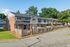 Brick two-story townhomes along a curving street at Shadowbrook Townhomes in Memphis, TN