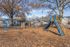 Playground with slides under mature shade trees at Shadowbrook Townhomes in Memphis, TN