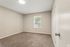 Second bedroom with carpet and natural light at Shadowbrook Townhomes in Memphis, TN