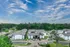 Aerial view of buildings among tall pine trees at Trails at Northpointe in Jackson, MS