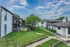 Apartment buildings along landscaped sidewalks at Trails at Northpointe in Jackson, MS
