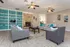Clubhouse lounge with stone fireplace and sofas at Trails at Northpointe in Jackson, MS