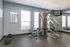 Fitness center with weight machine and free weights at Trails at Northpointe in Jackson, MS