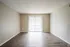 Living room with wood-style floors and patio door at Trails at Northpointe in Jackson, MS