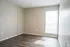 Second bedroom with natural light and wood-style floors at Trails at Northpointe in Jackson, MS