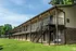 Brick and siding building with covered walkways at Windsor Place Apartments in Memphis, TN