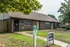 Brick leasing office with walkway and signage at Windsor Place Apartments in Memphis, TN