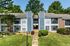 Two-story apartment building with green lawn at The Meadows Apartments in Memphis, TN