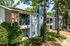 Brick building with private balconies and mature trees at The Meadows Apartments in Memphis, TN