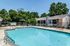 Sparkling outdoor pool with lounge deck at The Meadows Apartments in Memphis, TN