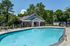 Resort-style pool in front of the clubhouse at The Meadows Apartments in Memphis, TN