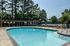 Pool with shaded pergola seating at The Meadows Apartments in Memphis, TN