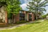 Brick apartment buildings with balconies and shade trees at Hickory Pointe in Memphis, TN