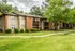 Two-story brick buildings along a wide green lawn at Hickory Pointe in Memphis, TN