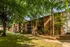 Shaded courtyard with brick apartments and tall trees at Hickory Pointe in Memphis, TN